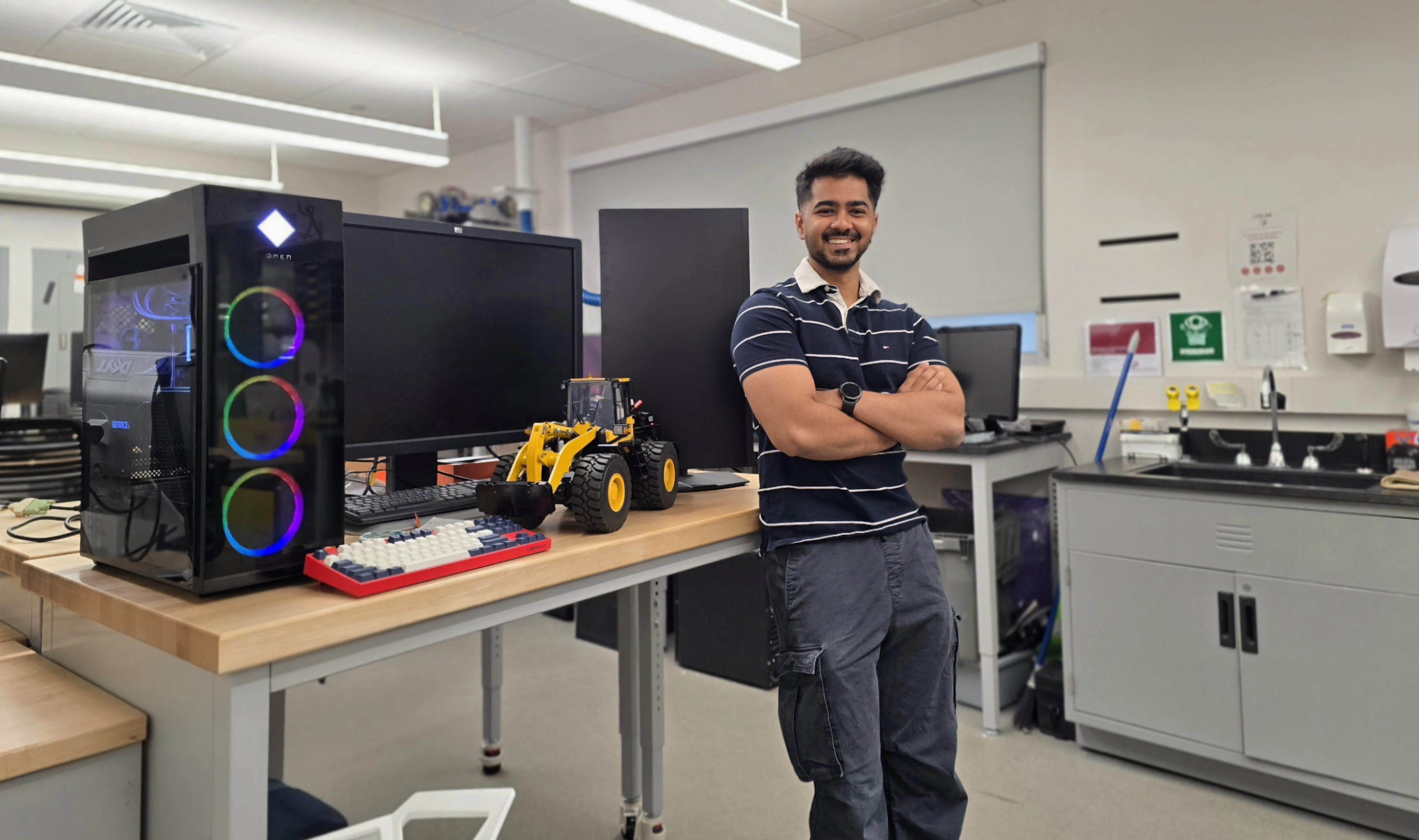 student stands in front of desk