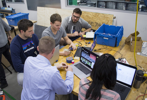 students and professor at table