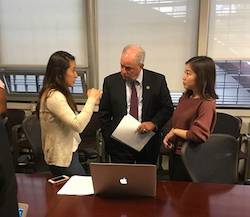 Congressman Doyle speaks with two students.