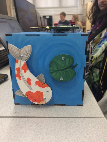 A pond-themed xylophone box displaying a koi fish and a lily pad.