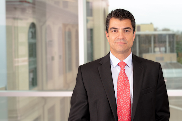 Professor Burak Ozdoganlar standing in Scott Hall