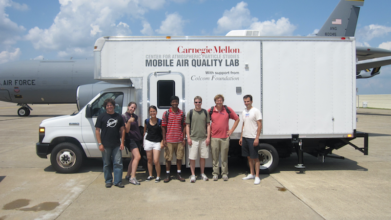 Robinson and researchers in front of the Mobile Air Quality  Lab