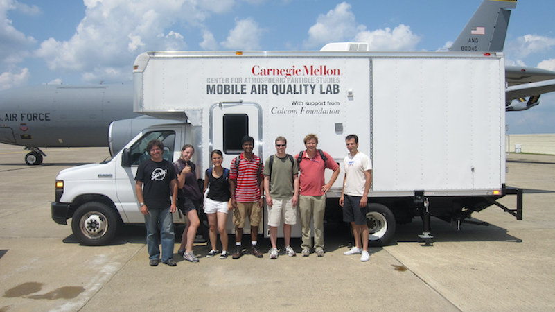 Robinson and researchers in front of the Mobile Air Quality Lab
