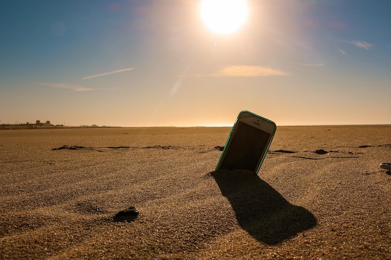 phone in the sand at the beach 