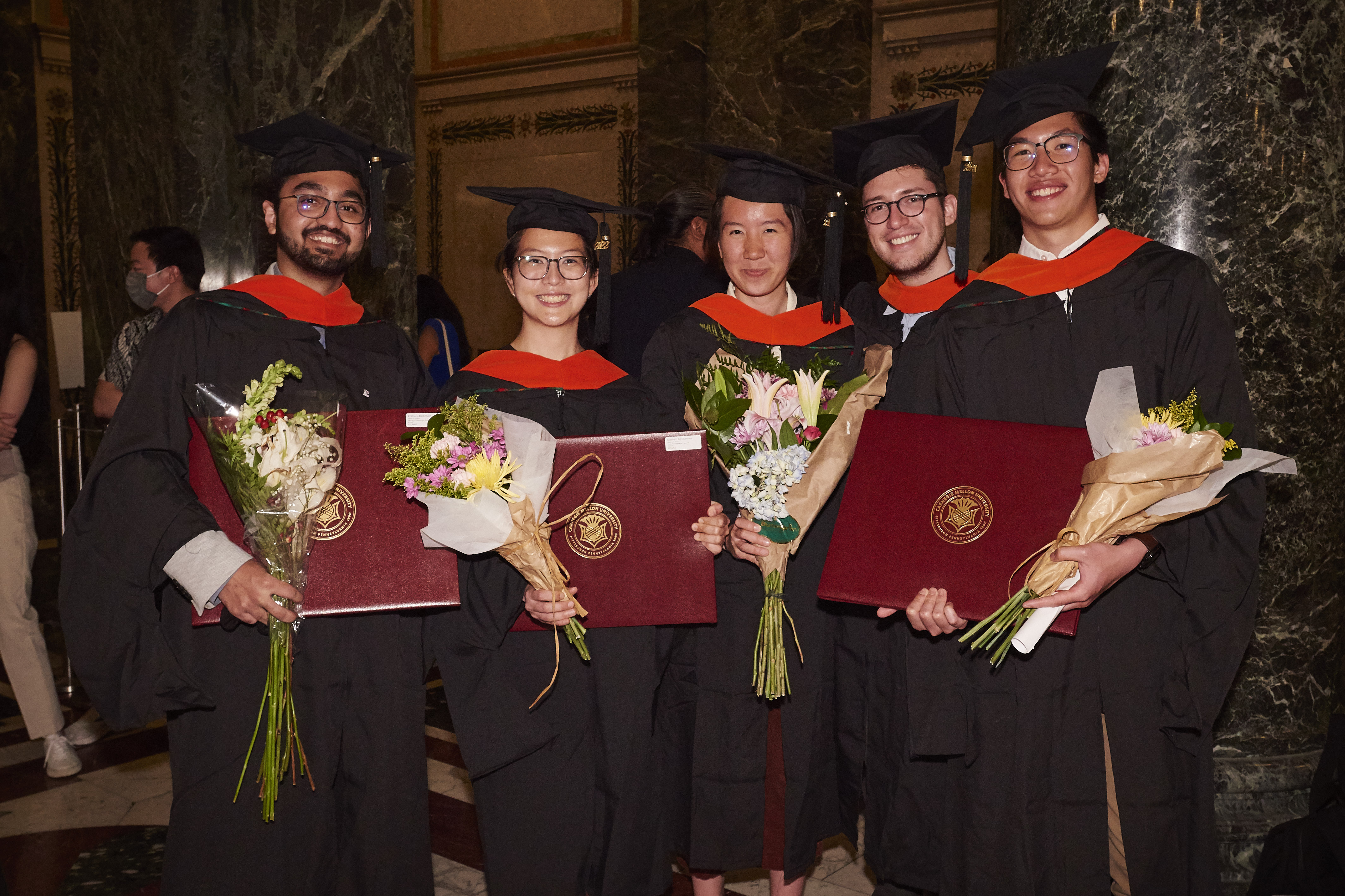 students in caps and gowns at graduation