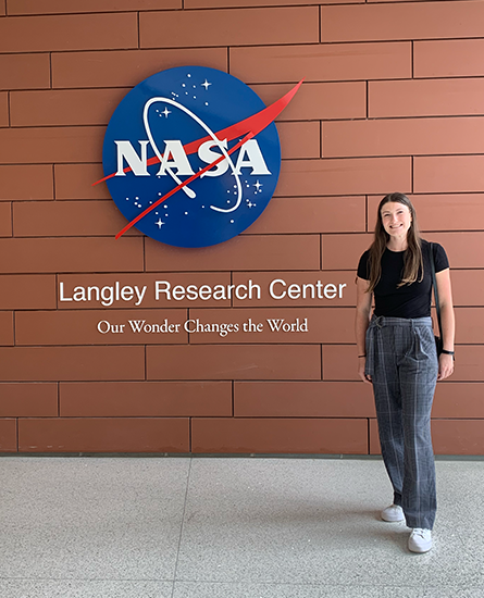woman standing in front of NASA sign