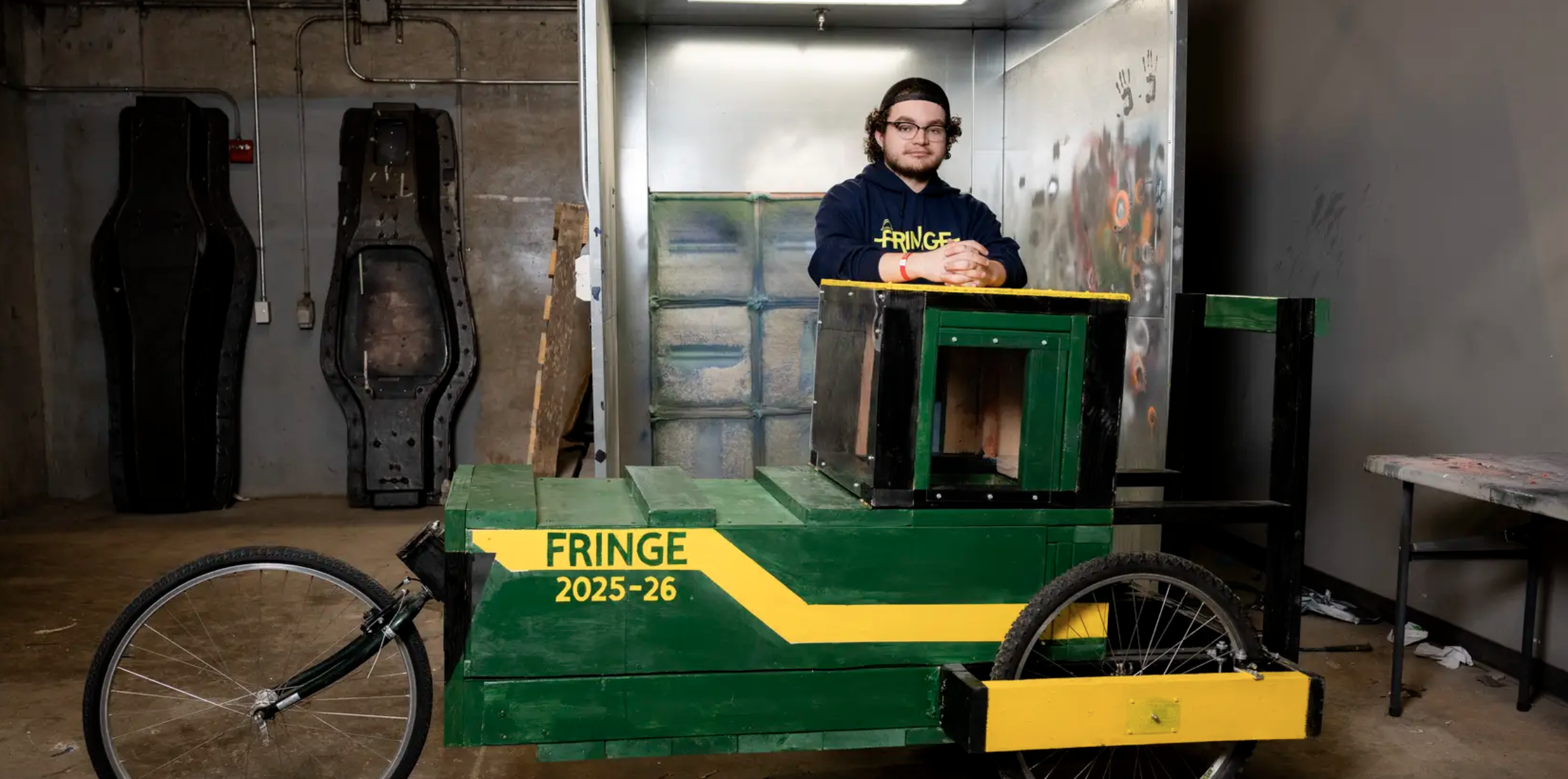 student standing behind buggy 