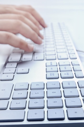 hand typing on a keyboard